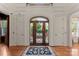 Elegant foyer with arched doorway, decorative glass door, and hardwood floors at 3314 Leamington Ln, Charlotte, NC 28226
