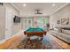 Spacious game room featuring a pool table, hardwood floors, and access to outdoor amenities at 3314 Leamington Ln, Charlotte, NC 28226
