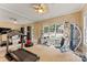 Bright home gym with a variety of equipment and large windows overlooking outdoor area at 3314 Leamington Ln, Charlotte, NC 28226