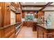 Spacious kitchen with rich wooden cabinets, granite countertops, and modern appliances, designed for functionality and style at 3314 Leamington Ln, Charlotte, NC 28226