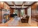 Cozy living room featuring a fireplace, wood paneled walls, and natural light at 3314 Leamington Ln, Charlotte, NC 28226
