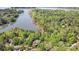 Scenic aerial view of lakefront homes surrounded by lush greenery and tranquil waters at 3508 Mountain Cove Dr, Charlotte, NC 28216