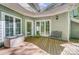 Inviting back porch area featuring a bench and doors to the interior, great for relaxing and enjoying the outdoors at 3508 Mountain Cove Dr, Charlotte, NC 28216