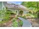 Landscaped backyard with a wooden walkway and green foliage, offering a peaceful and private outdoor space at 3508 Mountain Cove Dr, Charlotte, NC 28216