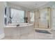 Luxurious bathroom with a garden tub, glass shower, and elegant window treatments at 3508 Mountain Cove Dr, Charlotte, NC 28216