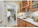 Butler's pantry area featuring wood cabinetry, a wet bar, and a view into the adjacent dining room at 3508 Mountain Cove Dr, Charlotte, NC 28216
