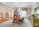 Elegant dining room with floral wallpaper, a large window, and a chandelier above a long wood table at 3508 Mountain Cove Dr, Charlotte, NC 28216
