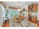 Cozy dining room featuring a wooden table, decorative rug, and natural light from a large window at 3508 Mountain Cove Dr, Charlotte, NC 28216