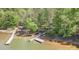 A lakefront with a pier featuring a covered area, providing a relaxing retreat by the water at 3508 Mountain Cove Dr, Charlotte, NC 28216
