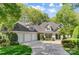 Charming two-story home featuring a three-car garage, well-manicured lawn, and lush landscaping at 3508 Mountain Cove Dr, Charlotte, NC 28216