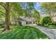 Charming two-story home featuring a three-car garage, well-manicured lawn, and lush landscaping at 3508 Mountain Cove Dr, Charlotte, NC 28216