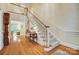 Inviting foyer with hardwood floors, staircase, and open view to the living room, blending classic charm and elegance at 3508 Mountain Cove Dr, Charlotte, NC 28216