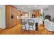 Open kitchen with wood cabinets, breakfast bar, and hardwood floors, creating a warm and functional cooking space at 3508 Mountain Cove Dr, Charlotte, NC 28216
