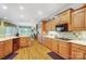 Spacious kitchen with wood cabinets, modern appliances, hardwood floors, and a seamless transition to the living area at 3508 Mountain Cove Dr, Charlotte, NC 28216