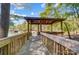 Scenic view of a lakeside gazebo and docks, enhancing the waterfront experience and charm of the property at 3508 Mountain Cove Dr, Charlotte, NC 28216
