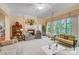Bright living room featuring a fireplace, large windows, comfortable seating, and a view to the exterior at 3508 Mountain Cove Dr, Charlotte, NC 28216