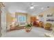 Bright living room featuring neutral walls, desk and seating area, and ample natural light at 3508 Mountain Cove Dr, Charlotte, NC 28216
