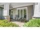 Cozy front porch with rocking chairs and stone columns, inviting relaxation and outdoor enjoyment at 3508 Mountain Cove Dr, Charlotte, NC 28216