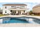 Backyard features an outdoor living area with comfortable seating, dining set, outdoor kitchen, and a refreshing pool at 405 Winding Oaks Se Ln, Concord, NC 28025