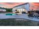 Beautiful backyard featuring a covered patio, outdoor kitchen, pool, and fire pit at 405 Winding Oaks Se Ln, Concord, NC 28025
