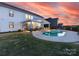 Backyard with pool, covered outdoor seating and kitchen area at 405 Winding Oaks Se Ln, Concord, NC 28025