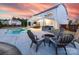 A spacious backyard with pool, covered outdoor kitchen, fire pit and outdoor seating at 405 Winding Oaks Se Ln, Concord, NC 28025