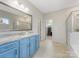 Bright bathroom features a shower, blue vanity with granite countertops, and ample storage for a luxurious feel at 405 Winding Oaks Se Ln, Concord, NC 28025