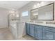 This bathroom boasts a soaking tub and a separate shower, complemented by a blue vanity and granite countertops at 405 Winding Oaks Se Ln, Concord, NC 28025