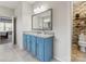 Updated bathroom showcasing a vanity with granite countertops, tile flooring, and a brick accent wall in the toilet nook at 405 Winding Oaks Se Ln, Concord, NC 28025
