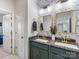 Elegant bathroom with dual sinks, modern fixtures, granite countertops and stylish wallpaper, exuding luxury and sophistication at 405 Winding Oaks Se Ln, Concord, NC 28025