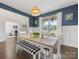 Cozy dining room with stylish decor, large windows, and a view into the adjacent office space at 405 Winding Oaks Se Ln, Concord, NC 28025