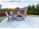 Charming backyard with a stone fire pit surrounded by comfortable seating, perfect for outdoor gatherings at 405 Winding Oaks Se Ln, Concord, NC 28025