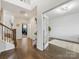 Inviting foyer with hardwood floors, staircase, and a view into a bright office with french doors at 405 Winding Oaks Se Ln, Concord, NC 28025