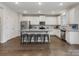 Open kitchen with granite countertops, stainless steel appliances, and breakfast bar at 405 Winding Oaks Se Ln, Concord, NC 28025