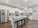Modern kitchen with granite countertops, stainless steel appliances, and kitchen island at 405 Winding Oaks Se Ln, Concord, NC 28025