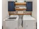 Close up of laundry machines and shelving, with plants, towels, and laundry related decorations at 405 Winding Oaks Se Ln, Concord, NC 28025