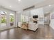 Living room with hardwood floors, french doors to a patio and backyard swimming pool at 405 Winding Oaks Se Ln, Concord, NC 28025