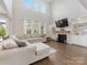 Bright living room with fireplace, built-in shelving, high ceilings and hardwood floors at 405 Winding Oaks Se Ln, Concord, NC 28025