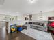 Spacious loft area with hardwood floors, comfortable seating, and a playful ' corner, perfect for relaxation at 405 Winding Oaks Se Ln, Concord, NC 28025