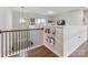 Cozy loft area with hardwood floors, natural light, and charming built-in bookcases, perfect for relaxing at 405 Winding Oaks Se Ln, Concord, NC 28025