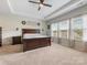 Spacious main bedroom features tray ceiling, natural light, and a wooden accent wall, creating a cozy and stylish retreat at 405 Winding Oaks Se Ln, Concord, NC 28025