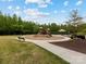 Community playground with a slide, benches, picnic tables, and shade at 405 Winding Oaks Se Ln, Concord, NC 28025