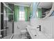 Stylish bathroom with glass-enclosed shower, marble vanity, and modern fixtures at 4147 Chelmsford Rd, Charlotte, NC 28211