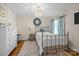 Cozy bedroom with a bronze metal bed frame, floral curtains and charming vintage-inspired décor at 4147 Chelmsford Rd, Charlotte, NC 28211
