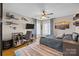 Well-lit bedroom featuring hardwood floors, ceiling fan, workspace and muted blue color scheme at 4147 Chelmsford Rd, Charlotte, NC 28211