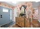 Inviting entryway with floral wallpaper, decorative mirror and storage cabinet at 4147 Chelmsford Rd, Charlotte, NC 28211