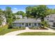 Charming one-story house with a well-manicured front yard, blue shutters and mature landscaping at 4147 Chelmsford Rd, Charlotte, NC 28211