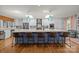 Bright kitchen with white cabinets, a large island with seating, and modern appliances at 4147 Chelmsford Rd, Charlotte, NC 28211