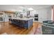 Bright kitchen with white cabinets, a large island with seating, and modern appliances at 4147 Chelmsford Rd, Charlotte, NC 28211