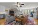 Bright living room featuring an entertainment center, hardwood floors, and a colorful area rug at 4147 Chelmsford Rd, Charlotte, NC 28211